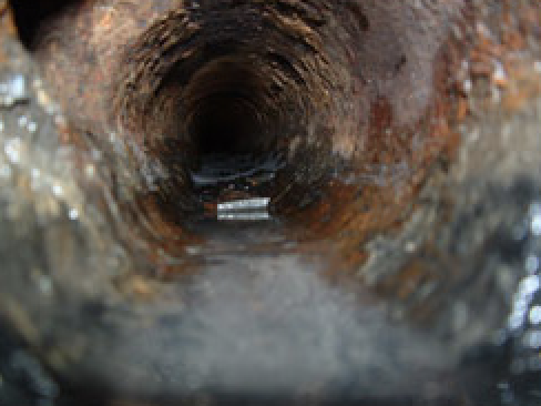 Inspection camera view of corroded pipe before repair